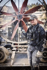 man standing in front of gigantic fan