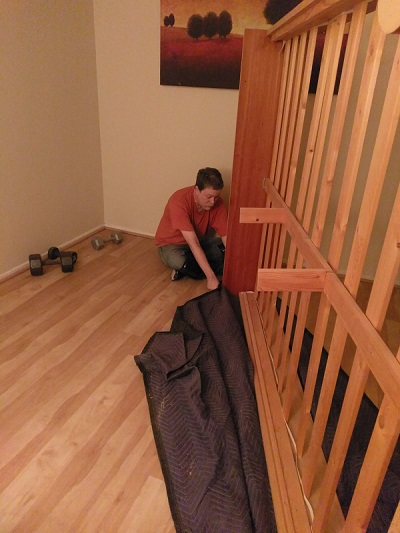 dragging a bedframe using a packing blanket.