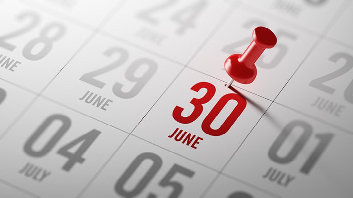 Push pin marking June 30 on calendar