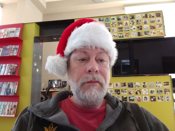 Author with white beard and Santa hat