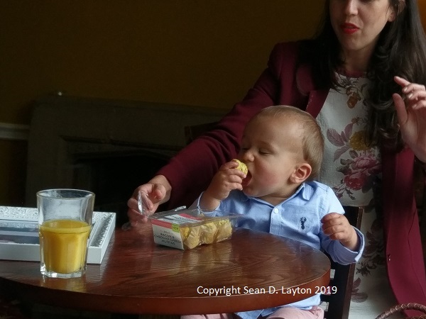 Baby Raphael eating a muffin